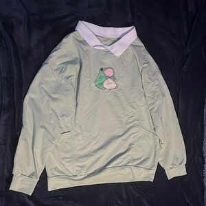 Light green oversized frog shirt.
